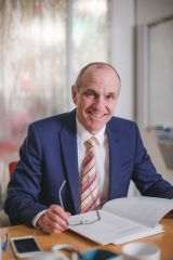 Craig Turner, Executive Director, OFT sitting at a work desk, smiling at the camera