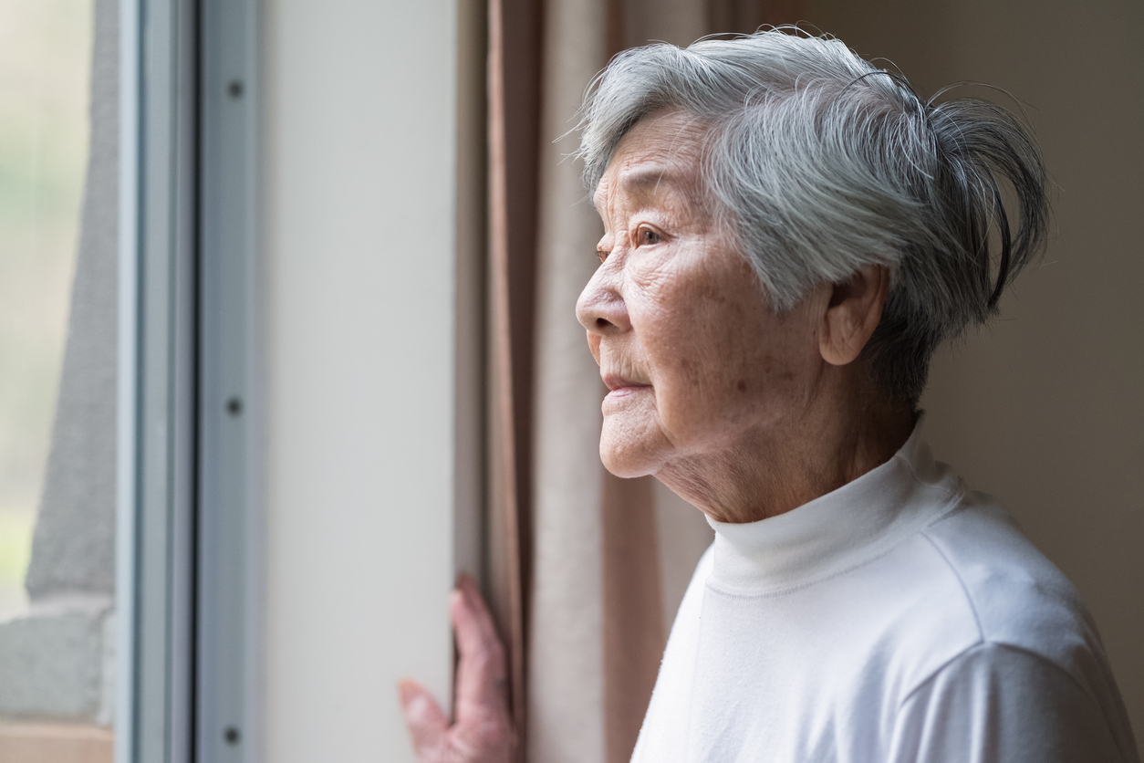 Older lady looking out her window